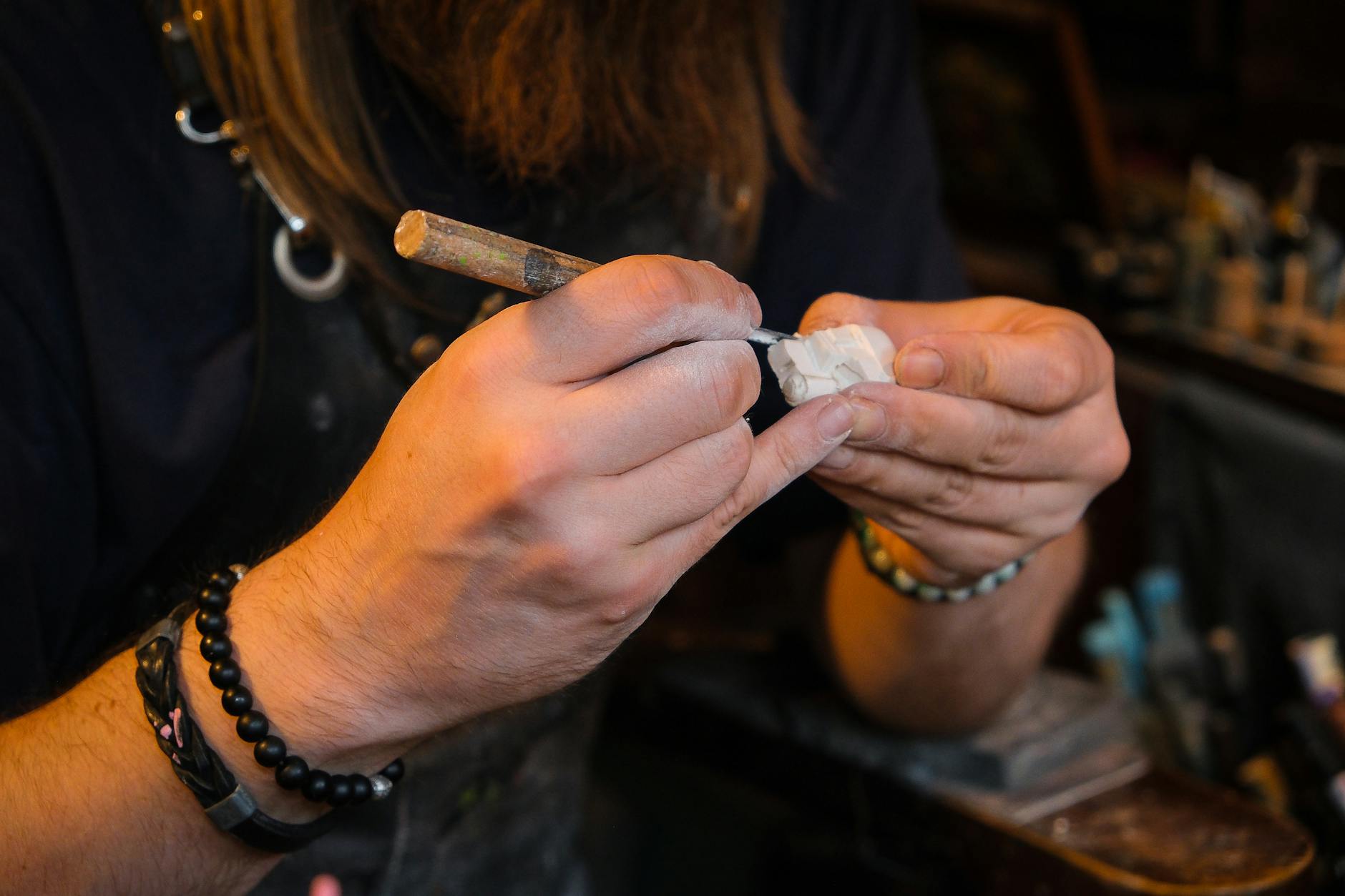 close up of artisan sculpting in workshop